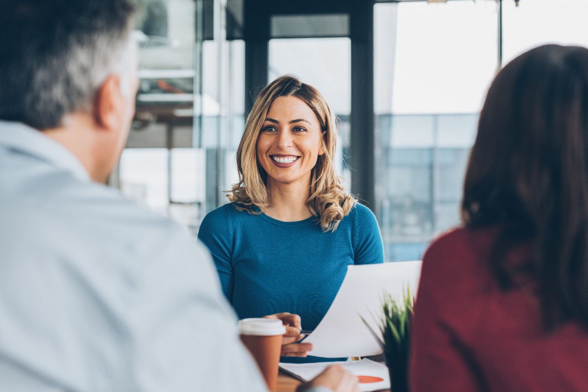 A finance adviser meeting with two business clients